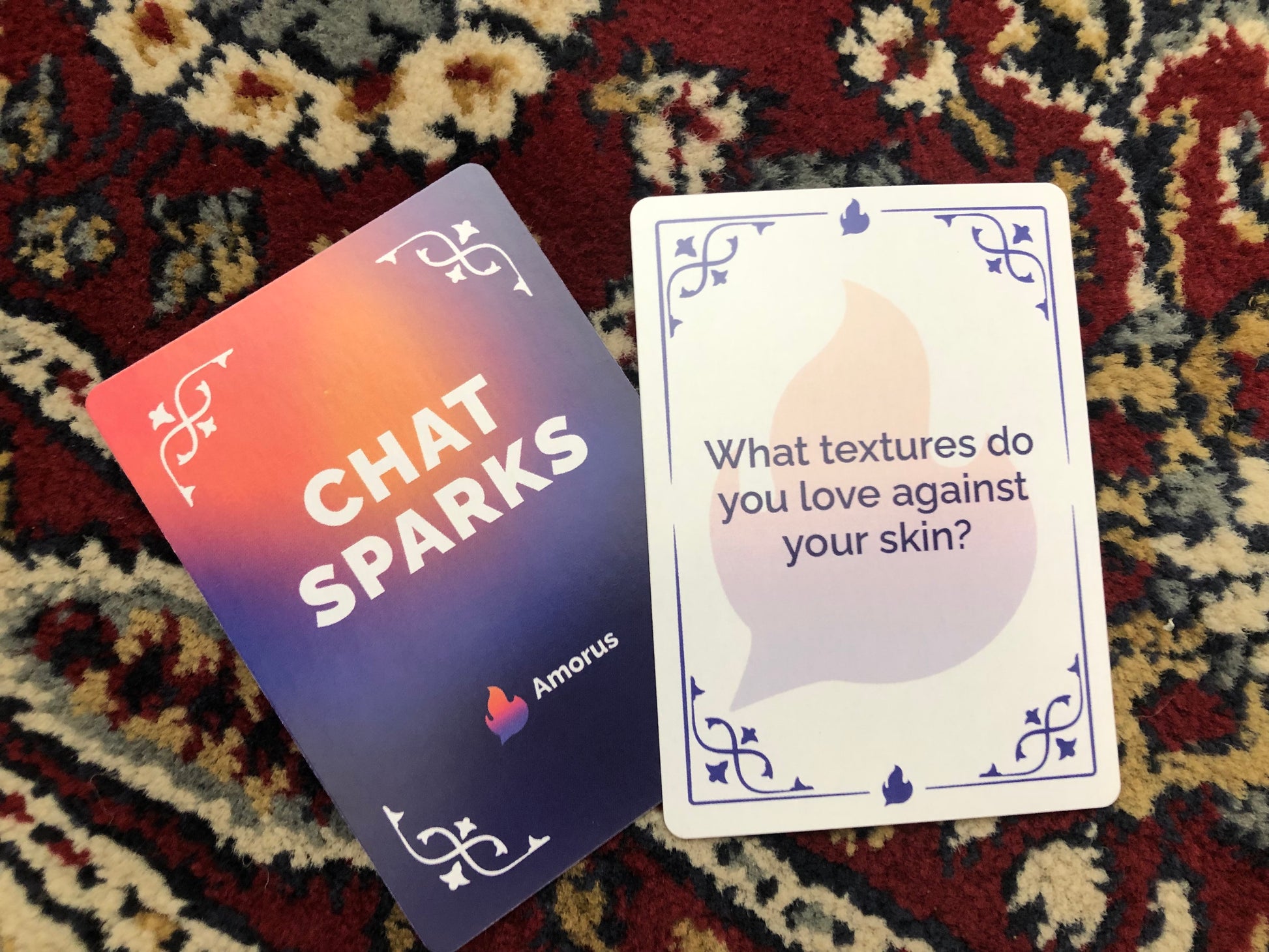Image of Chat Sparks game card on persian rug. Card reads "What textures do you love against your skin?"